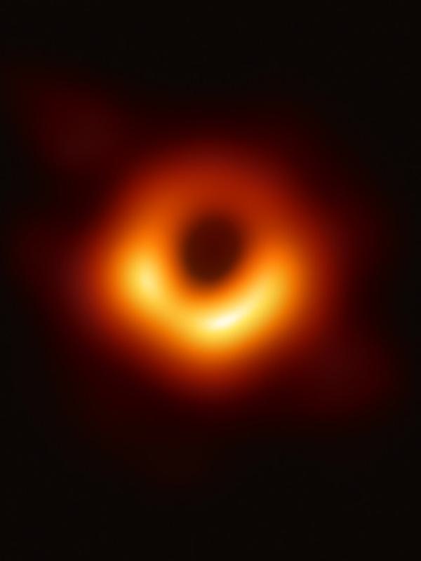 La première image d'un trou noir : un anneau de matière incandescente orange autour d'une ombre circulaire noire.